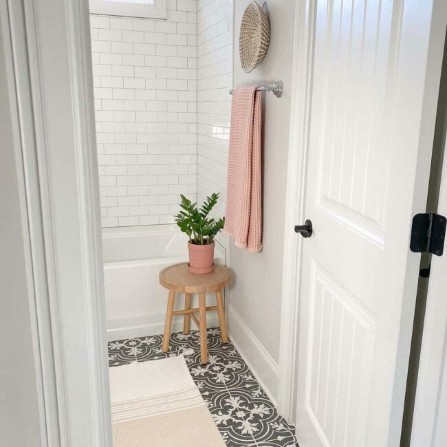 Dark Geometric Tiles Meet Sculptural Trim