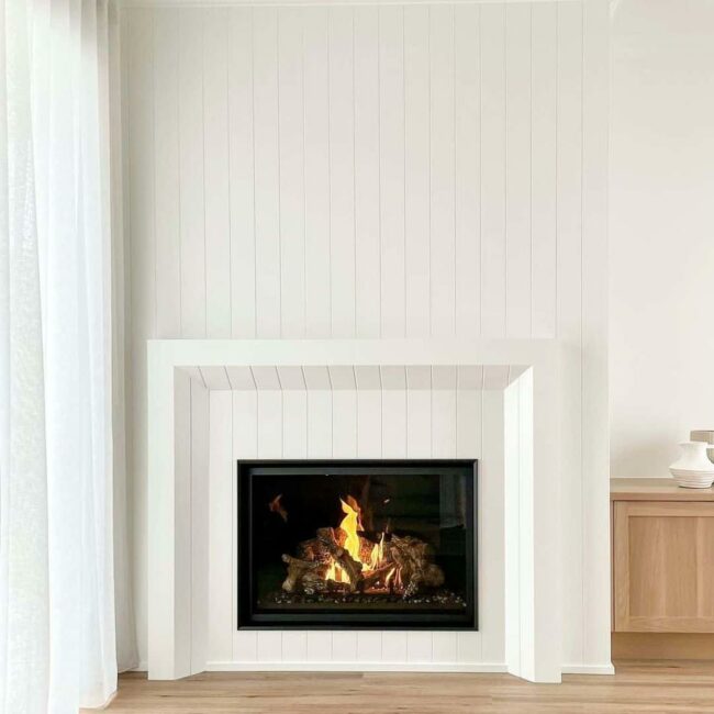 White Shiplap Frames Dramatic Black Fireplace