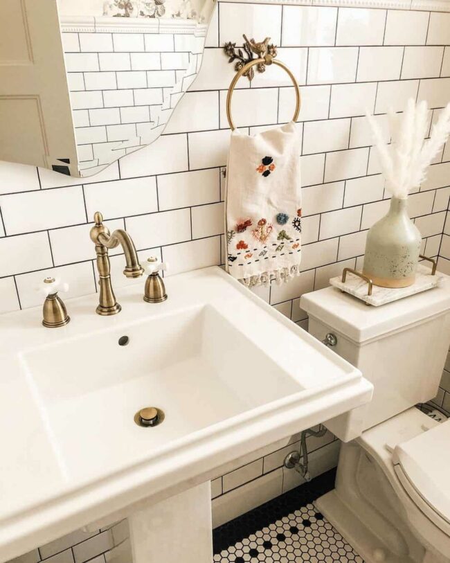 White Pedestal Sink Meets Brass Vintage