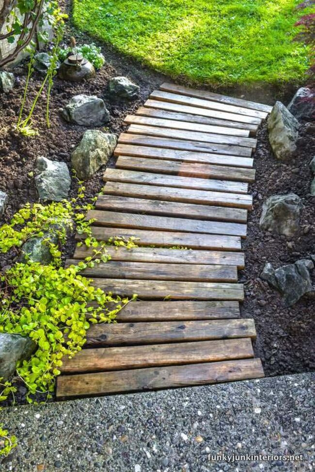 Weathered Wood Pathway Through Green Landscape