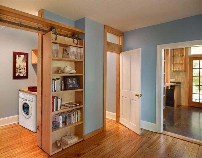 Sliding Wooden Bookcase Hides Laundry