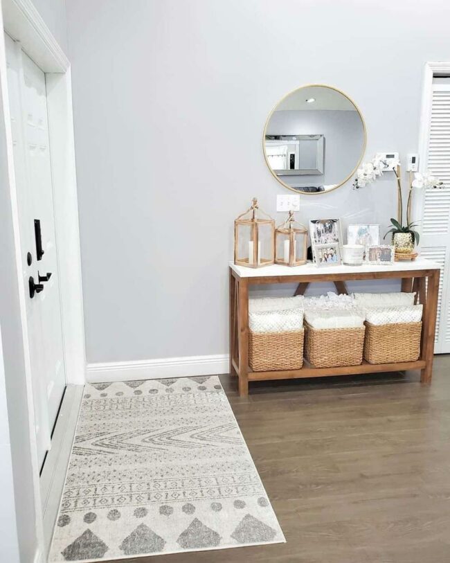 Gold-Framed Mirror Defines Woodgrain Entryway