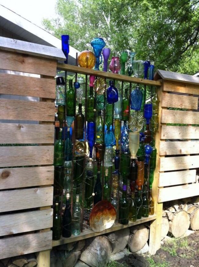 Kaleidoscopic Bottles Dancing Through Fence